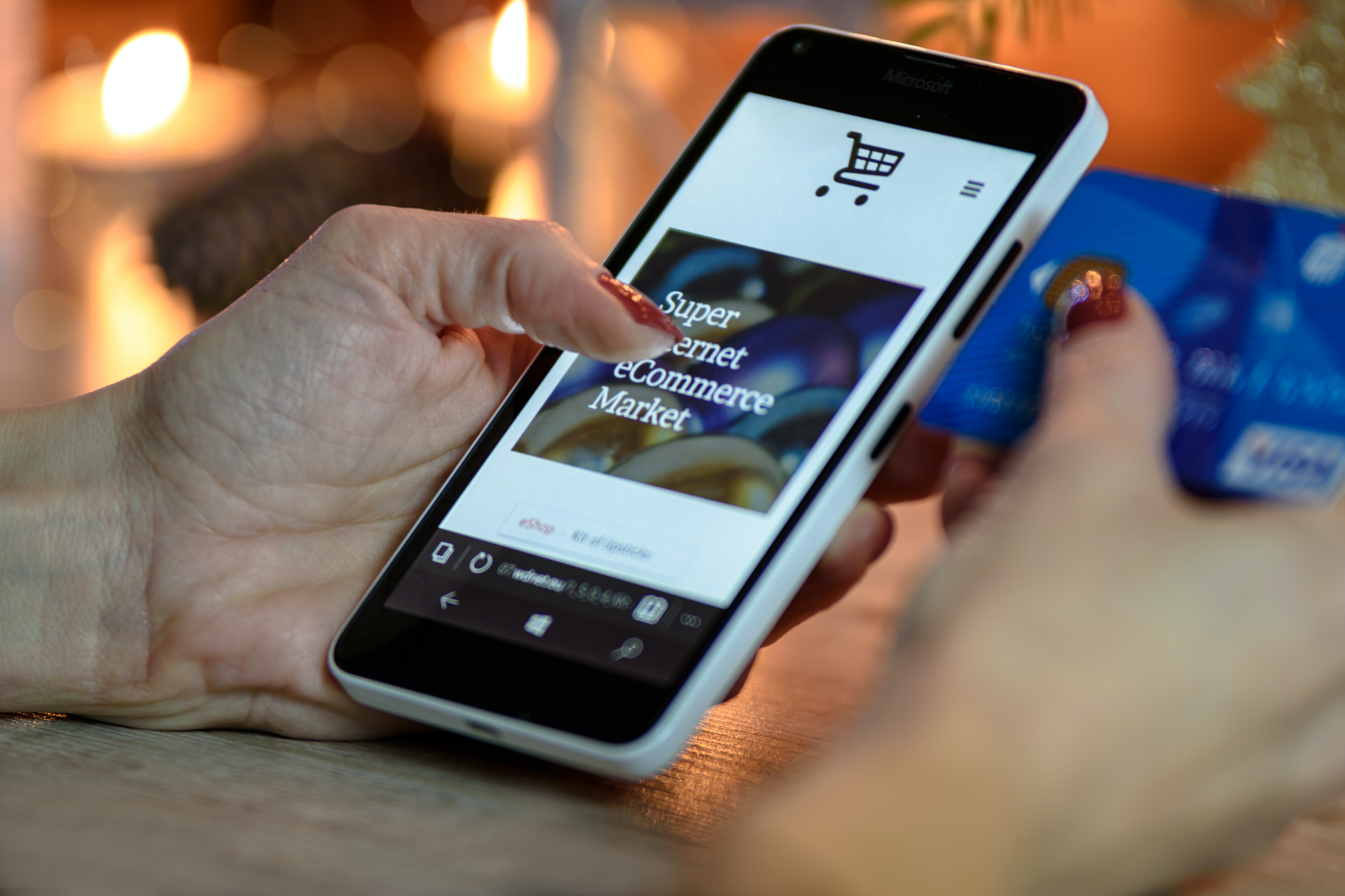 A girl is using her phone to browse a shopping website.